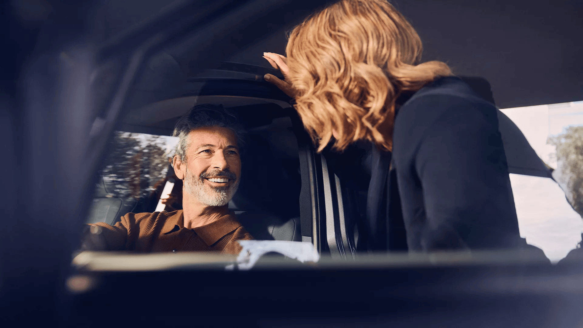 Customer speaking with a Lexus centre representative beside a vehicle